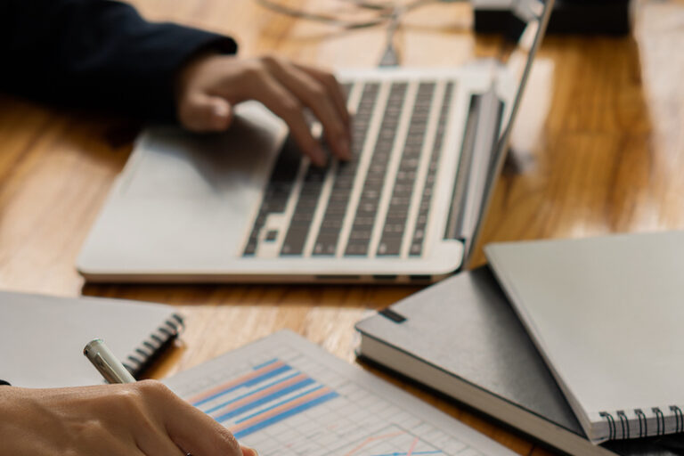An accountant uses a calculator and computer while sticking to the concept of business accounting. Budget and Loan Hands of people making money and calculating expenses at the office vertical picture computer laptop